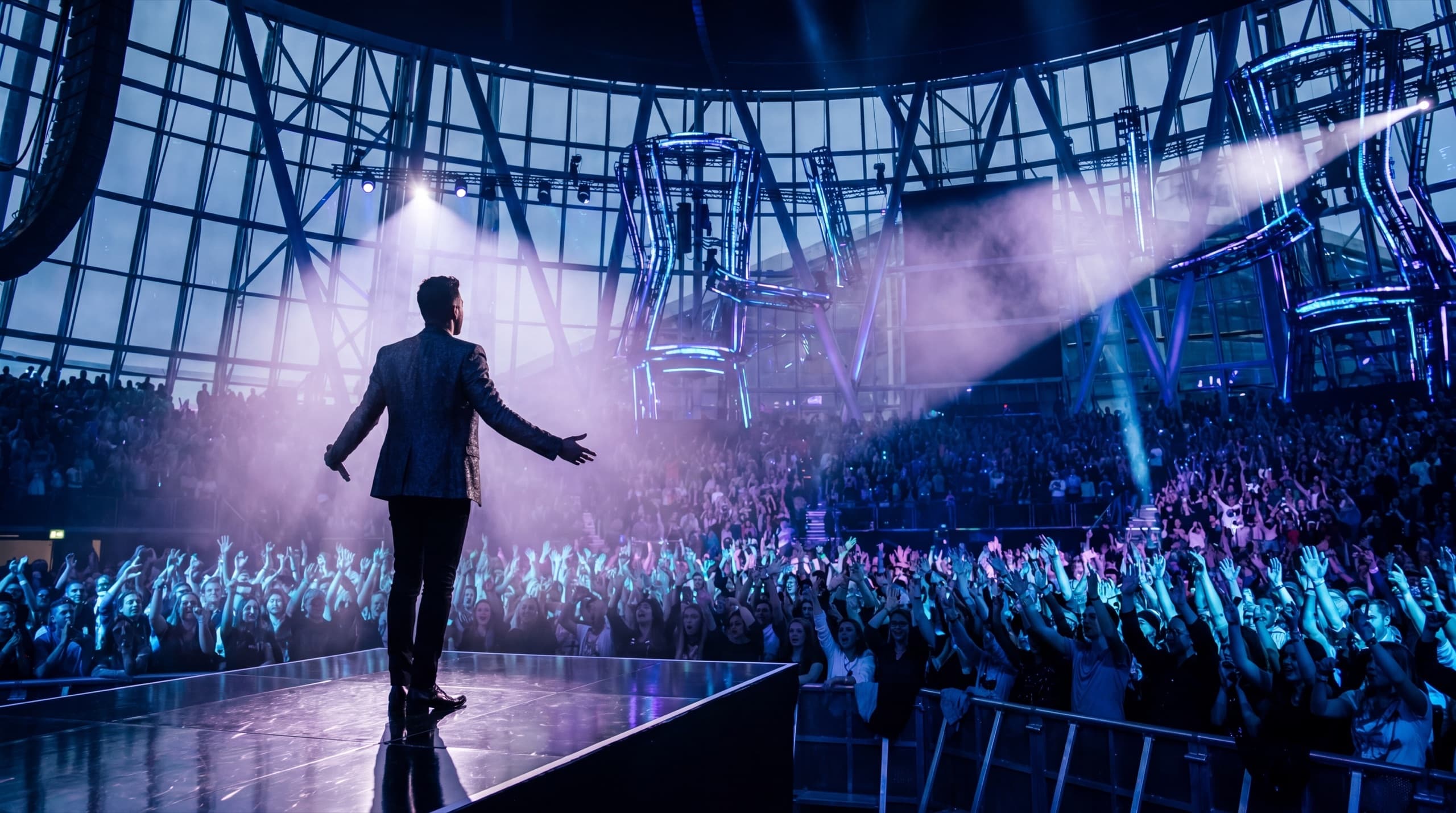 Performer facing a crowd from a concert stage